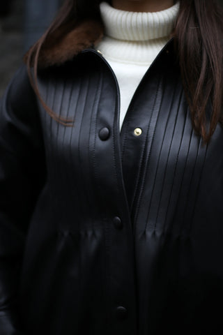 Leather jacket with natural fur–trimmed collar